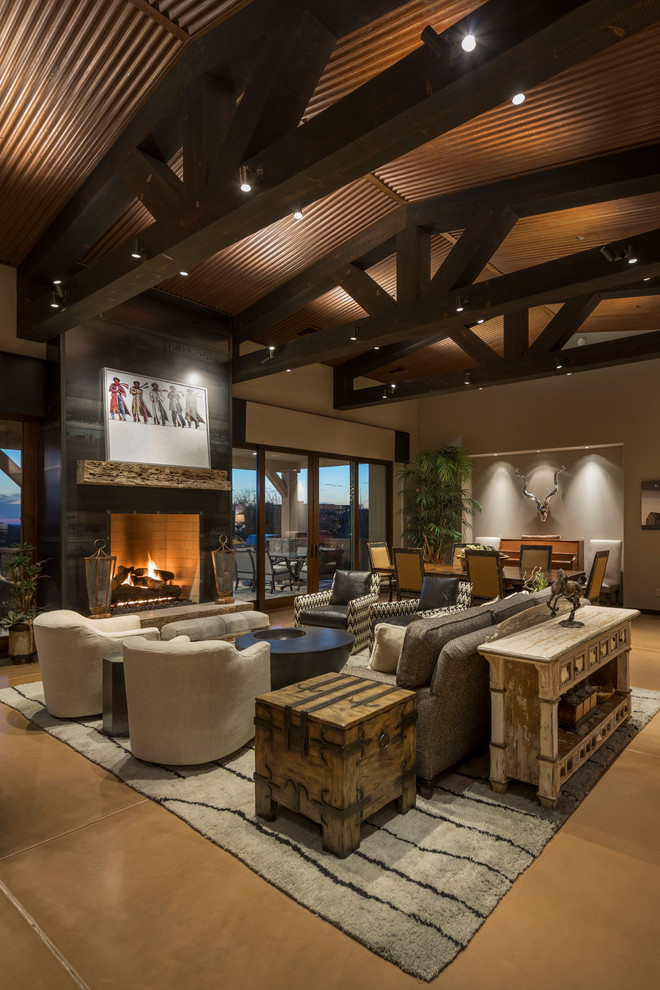 Inspiration for a large open concept living room in Phoenix with beige walls, concrete floors, a standard fireplace, a metal fireplace surround and a wall-mounted tv.