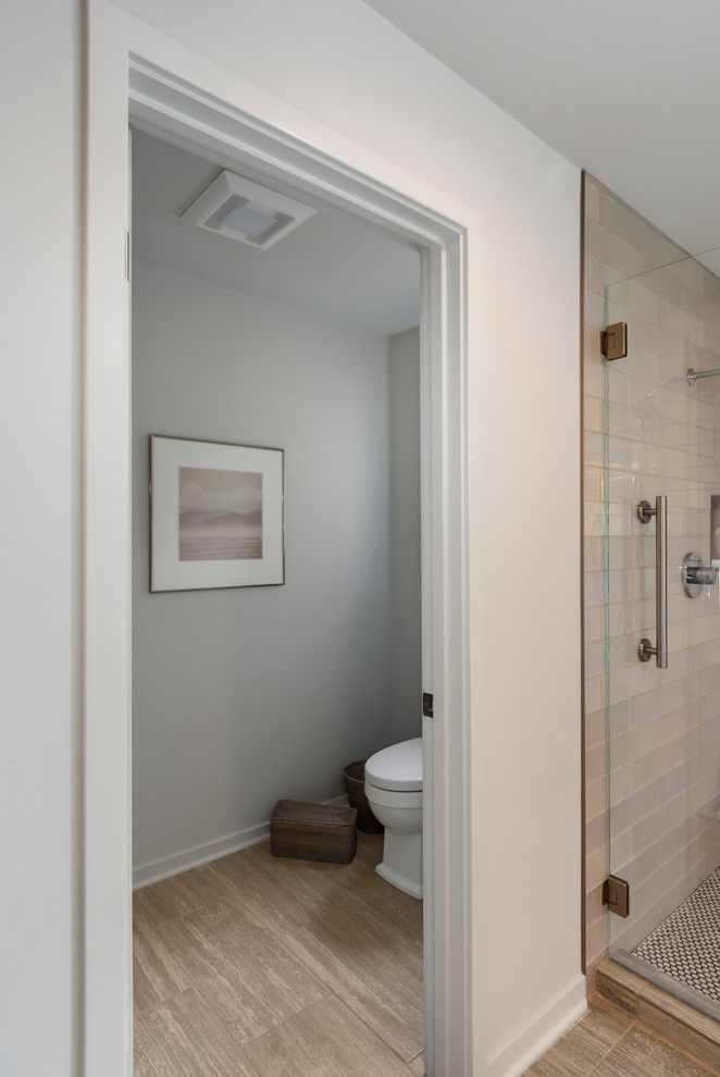 Large transitional master bathroom in Seattle with recessed-panel cabinets, grey cabinets, a freestanding tub, a double shower, a one-piece toilet, beige tile, glass tile, grey walls, porcelain floors, a vessel sink, engineered quartz benchtops, grey floor and a hinged shower door.