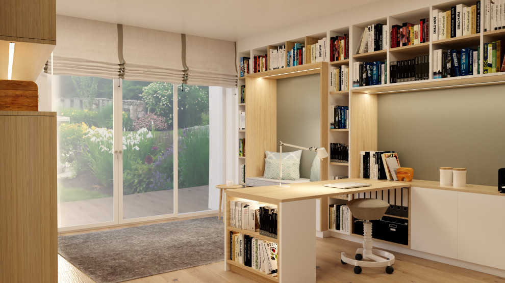 Photo of a large scandinavian home office in Munich with a library, green walls, medium hardwood floors and a built-in desk.