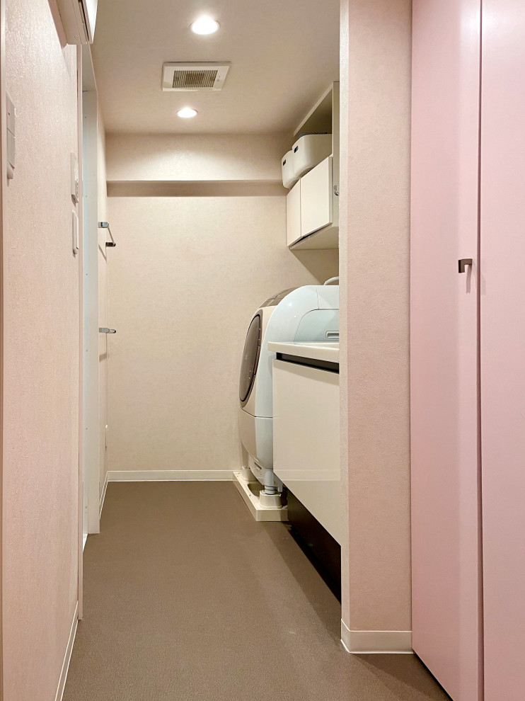 This is an example of a small contemporary single-wall utility room in Tokyo with an integrated sink, flat-panel cabinets, white cabinets, solid surface benchtops, grey walls, vinyl floors, an integrated washer and dryer, brown floor, white benchtop, wallpaper and wallpaper.