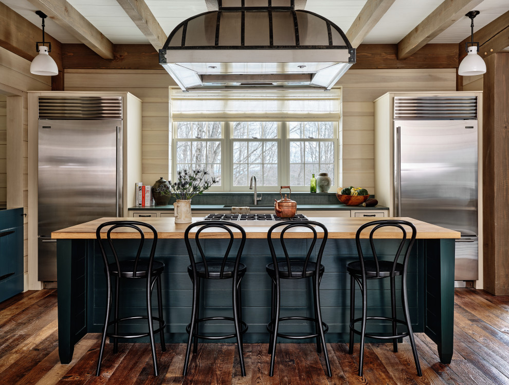 Design ideas for a country galley kitchen in Burlington with an undermount sink, beige cabinets, stainless steel appliances, dark hardwood floors, with island, brown floor, grey benchtop and exposed beam.