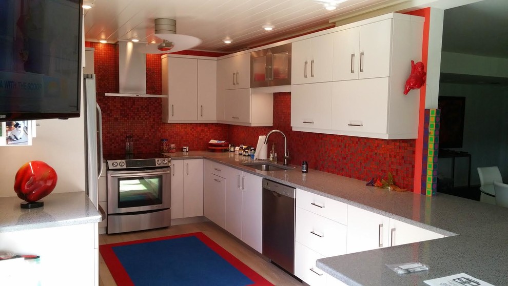 Mid-sized eclectic single-wall enclosed kitchen photo with beaded inset cabinets, white cabinets, granite countertops, metallic backsplash, stainless steel appliances and no island