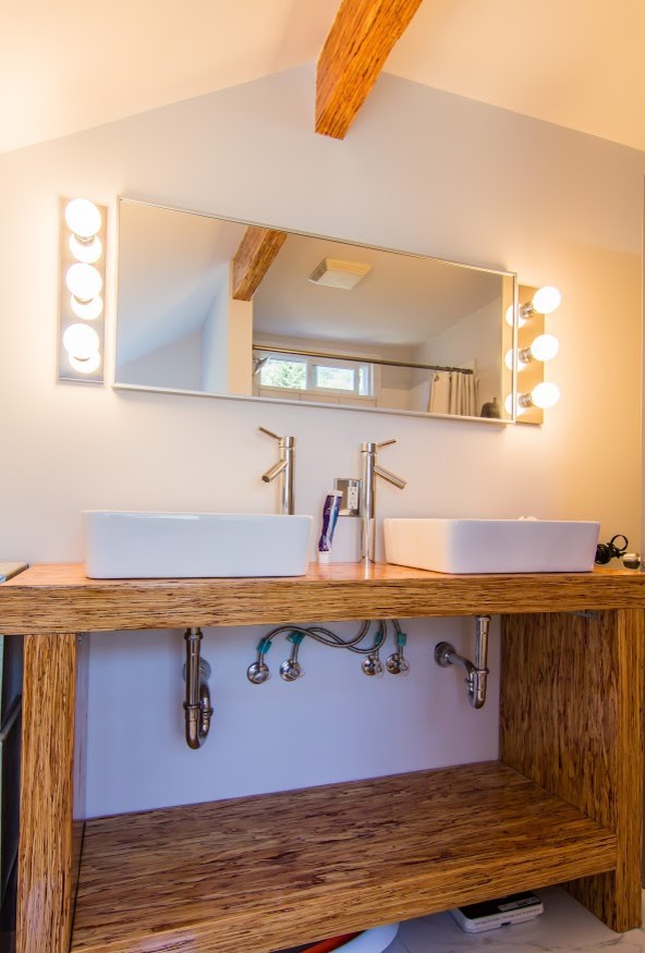 Mid-sized modern 3/4 bathroom in Vancouver with open cabinets, brown cabinets, a shower/bathtub combo, a one-piece toilet, beige walls, dark hardwood floors, a drop-in sink, wood benchtops, brown floor and a shower curtain.