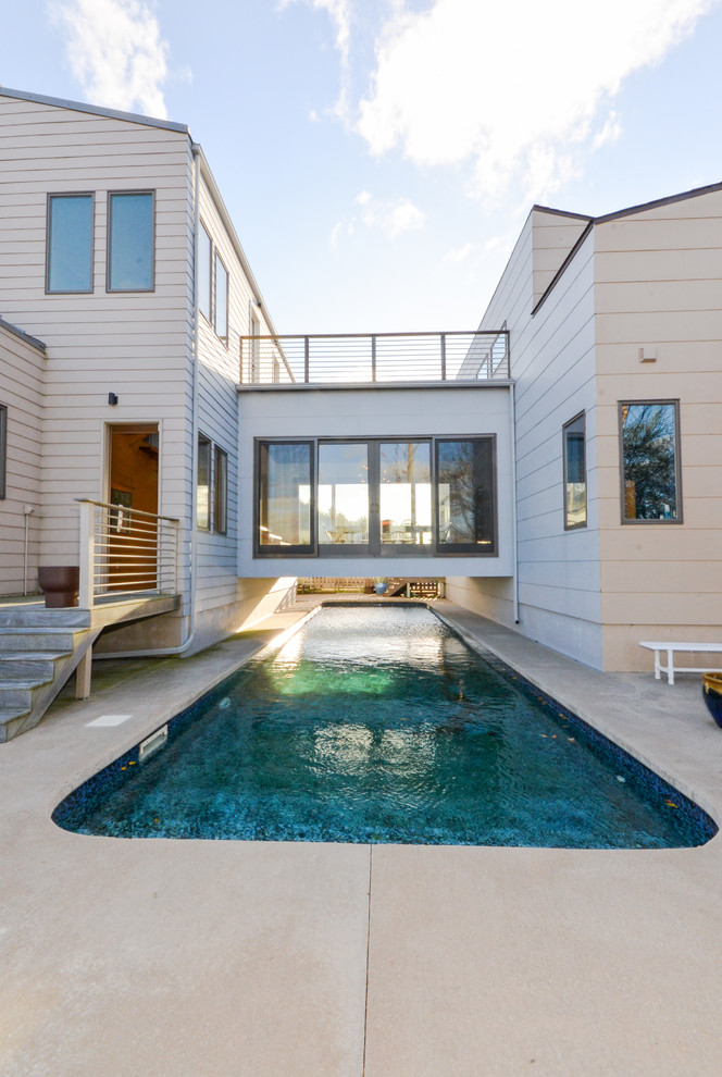 Photo of a contemporary courtyard lap pool in Other.
