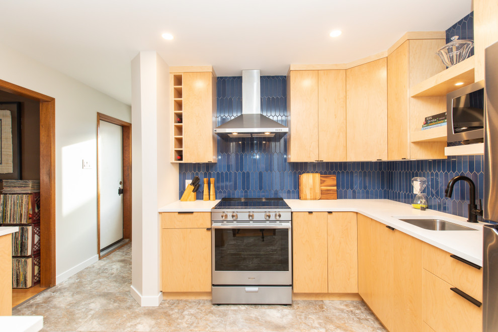 Photo of a medium sized modern l-shaped enclosed kitchen in Other with a submerged sink, flat-panel cabinets, light wood cabinets, engineered stone countertops, blue splashback, ceramic splashback, stainless steel appliances, vinyl flooring, no island, beige floors and white worktops.
