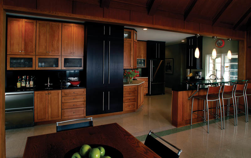 Huge transitional kitchen photo in Indianapolis with black backsplash, black appliances and an island