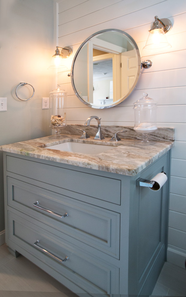 Mid-sized transitional 3/4 bathroom in Boston with beaded inset cabinets, blue cabinets, a two-piece toilet, gray tile, porcelain tile, green walls, porcelain floors, an undermount sink, quartzite benchtops and grey floor.