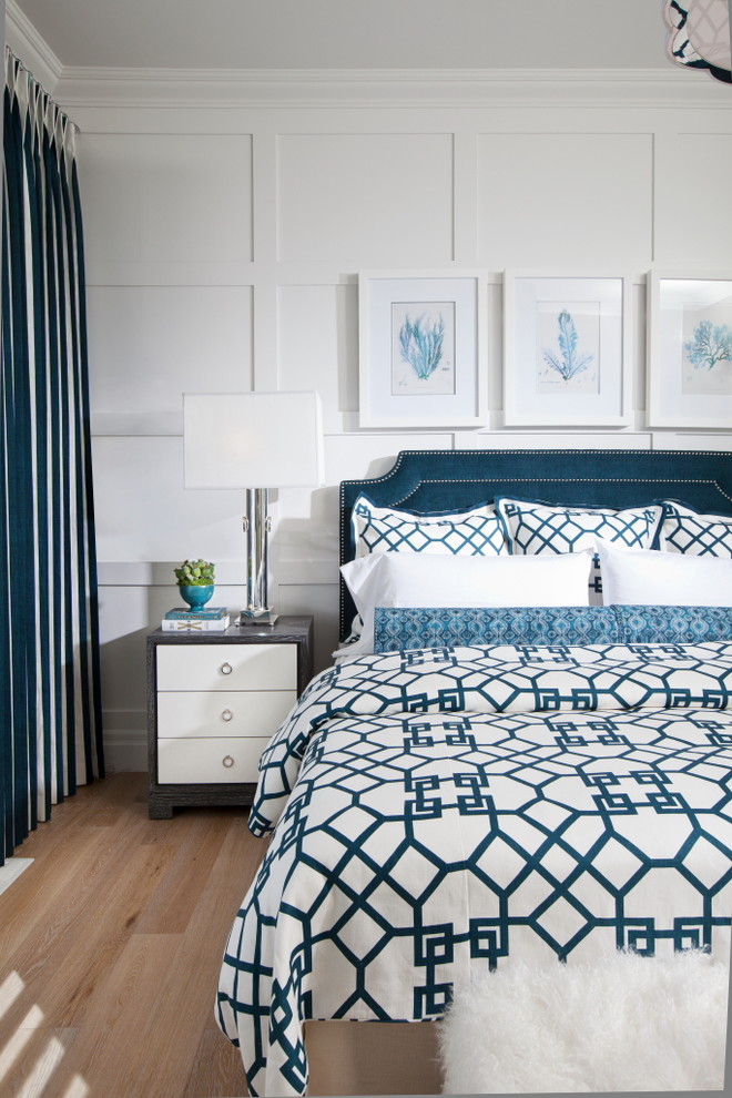 Design ideas for a traditional bedroom in New York with white walls and medium hardwood floors.