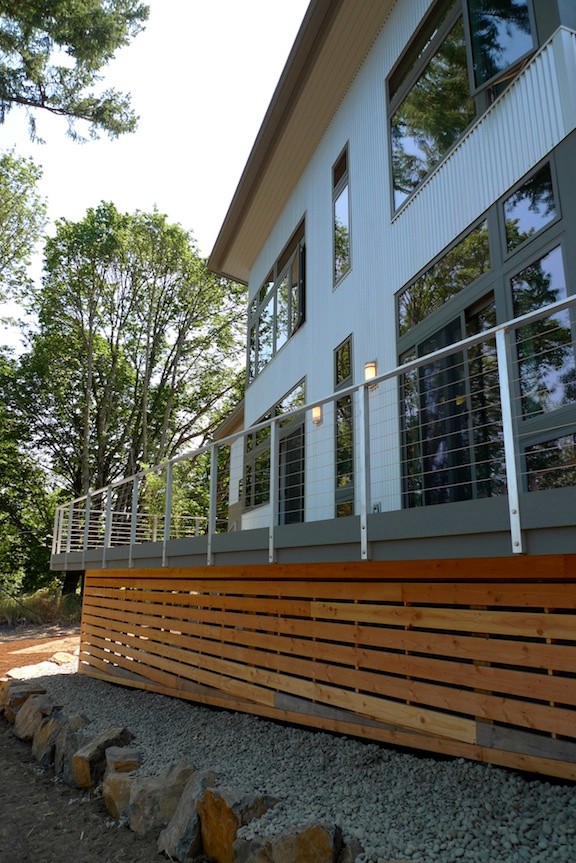Photo of a large contemporary two-storey grey exterior in Portland with metal siding and a flat roof.