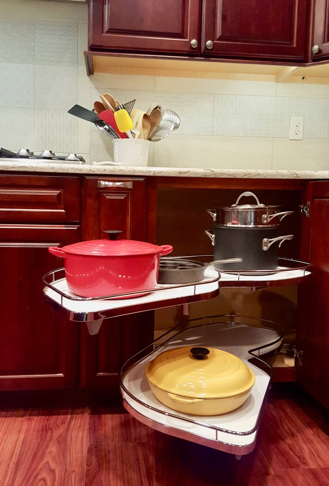 Example of a huge transitional u-shaped medium tone wood floor eat-in kitchen design with a double-bowl sink, raised-panel cabinets, dark wood cabinets, quartz countertops, beige backsplash, ceramic backsplash, stainless steel appliances and an island