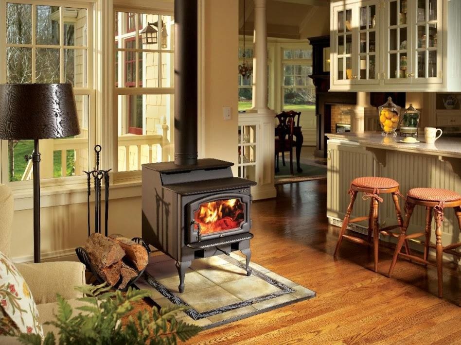 Design ideas for a mid-sized open concept living room in New York with a library, beige walls, medium hardwood floors, a wood stove, a tile fireplace surround and a built-in media wall.