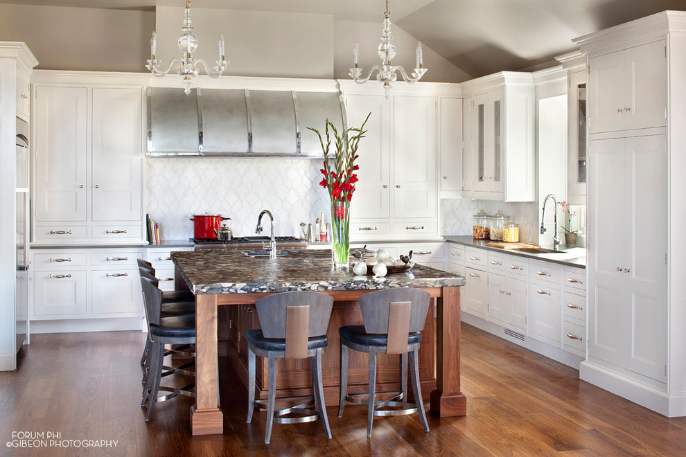Eat-in kitchen - transitional u-shaped eat-in kitchen idea in Denver with an undermount sink, raised-panel cabinets, white cabinets, quartz countertops, metallic backsplash, mosaic tile backsplash and stainless steel appliances