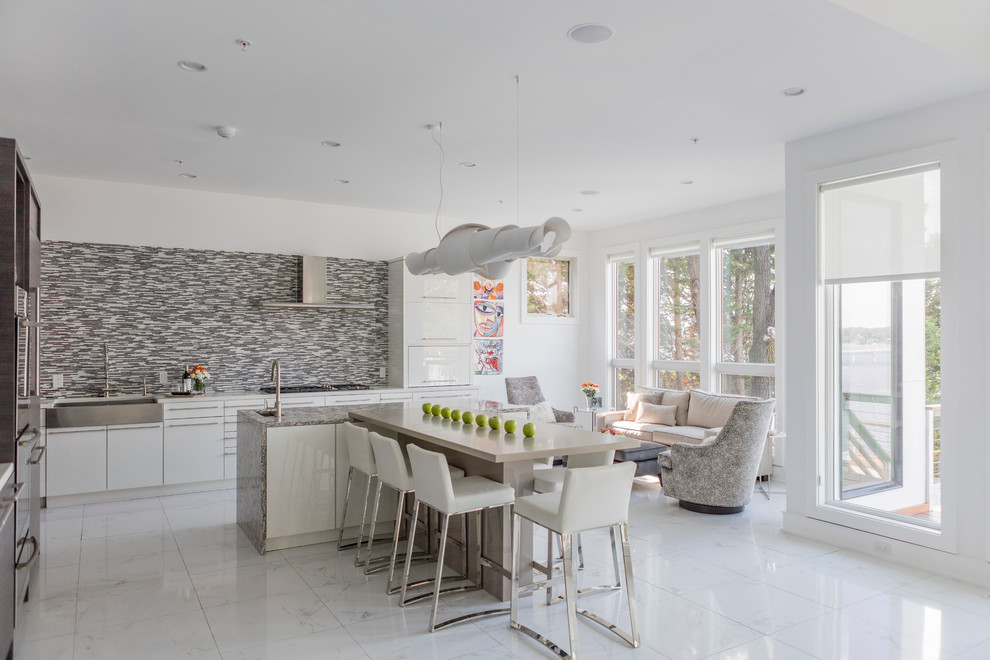 Large contemporary eat-in kitchen in DC Metro with an undermount sink, flat-panel cabinets, grey cabinets, granite benchtops, grey splashback, ceramic splashback, stainless steel appliances, marble floors and with island.