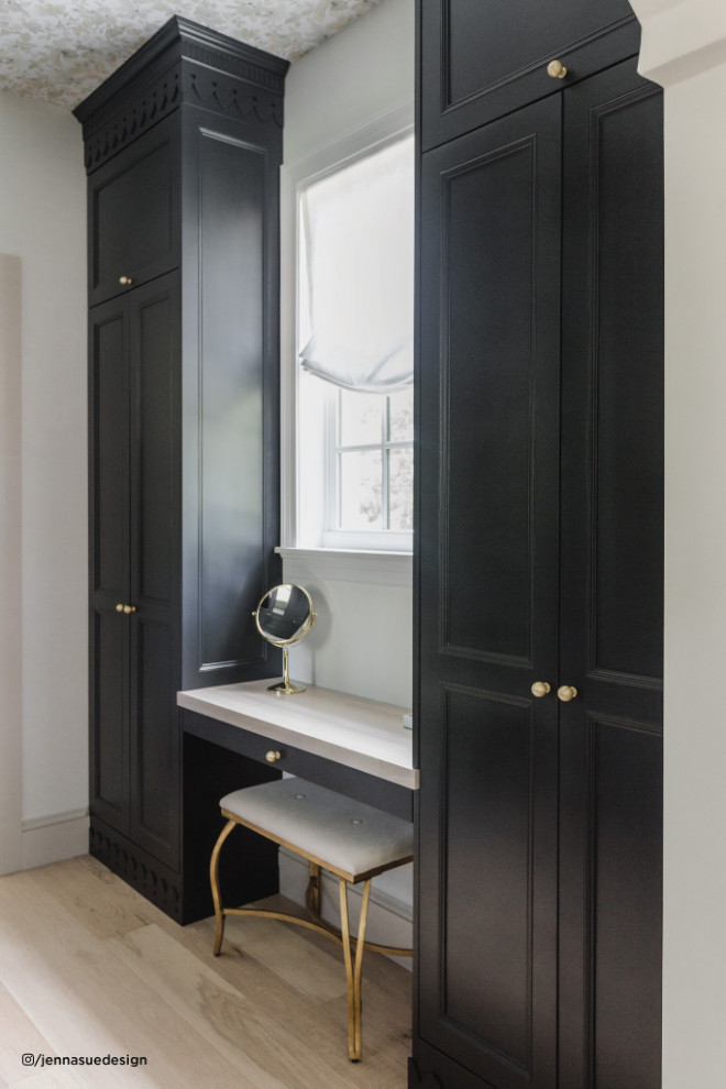 This is an example of a small classic gender neutral built-in wardrobe in Tampa with shaker cabinets, black cabinets, light hardwood flooring and a wallpapered ceiling.