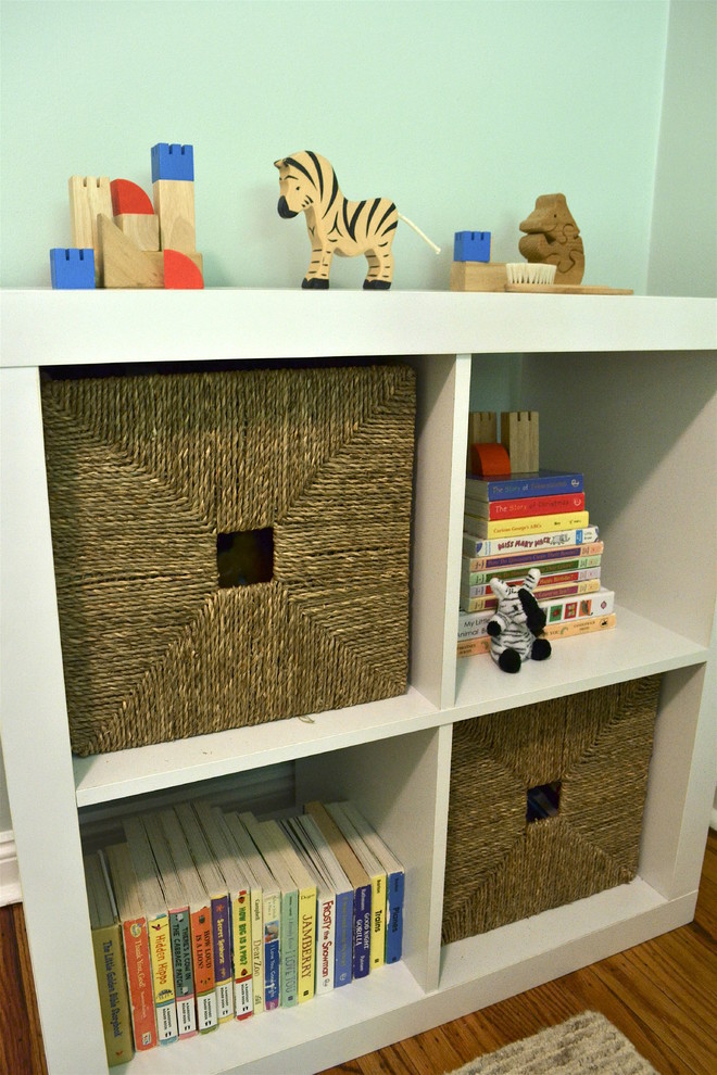 Photo of a small transitional nursery for boys in Philadelphia with blue walls and medium hardwood floors.