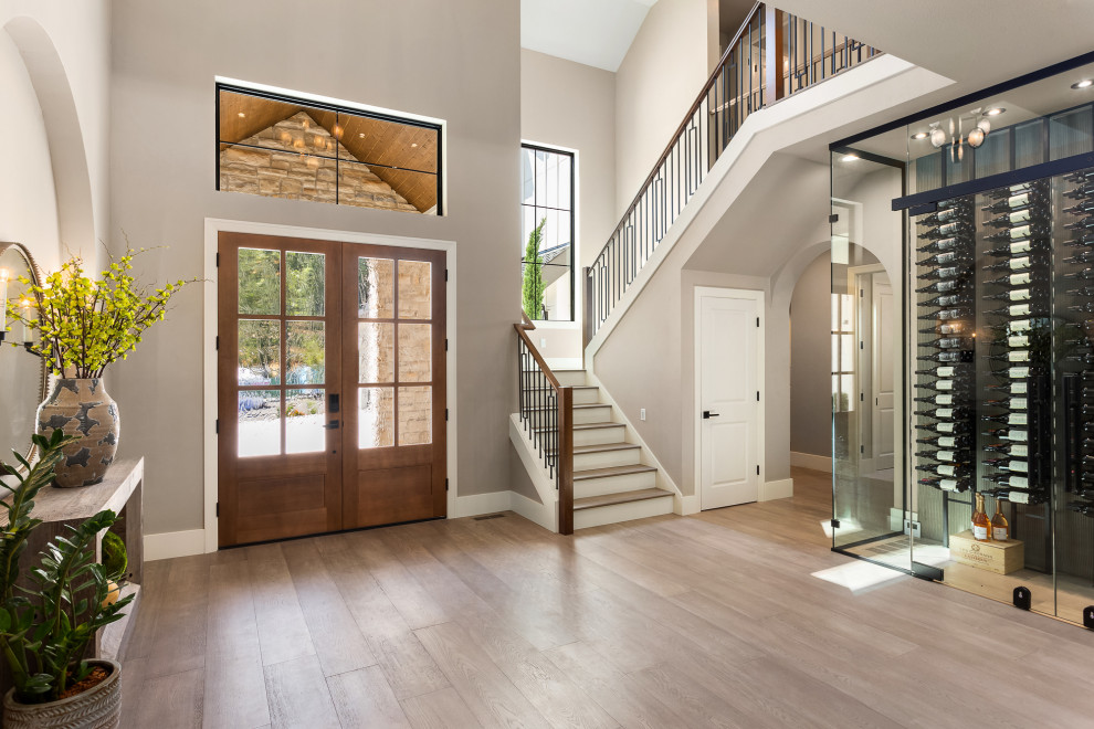 Entryway - modern medium tone wood floor and brown floor entryway idea in Portland with gray walls