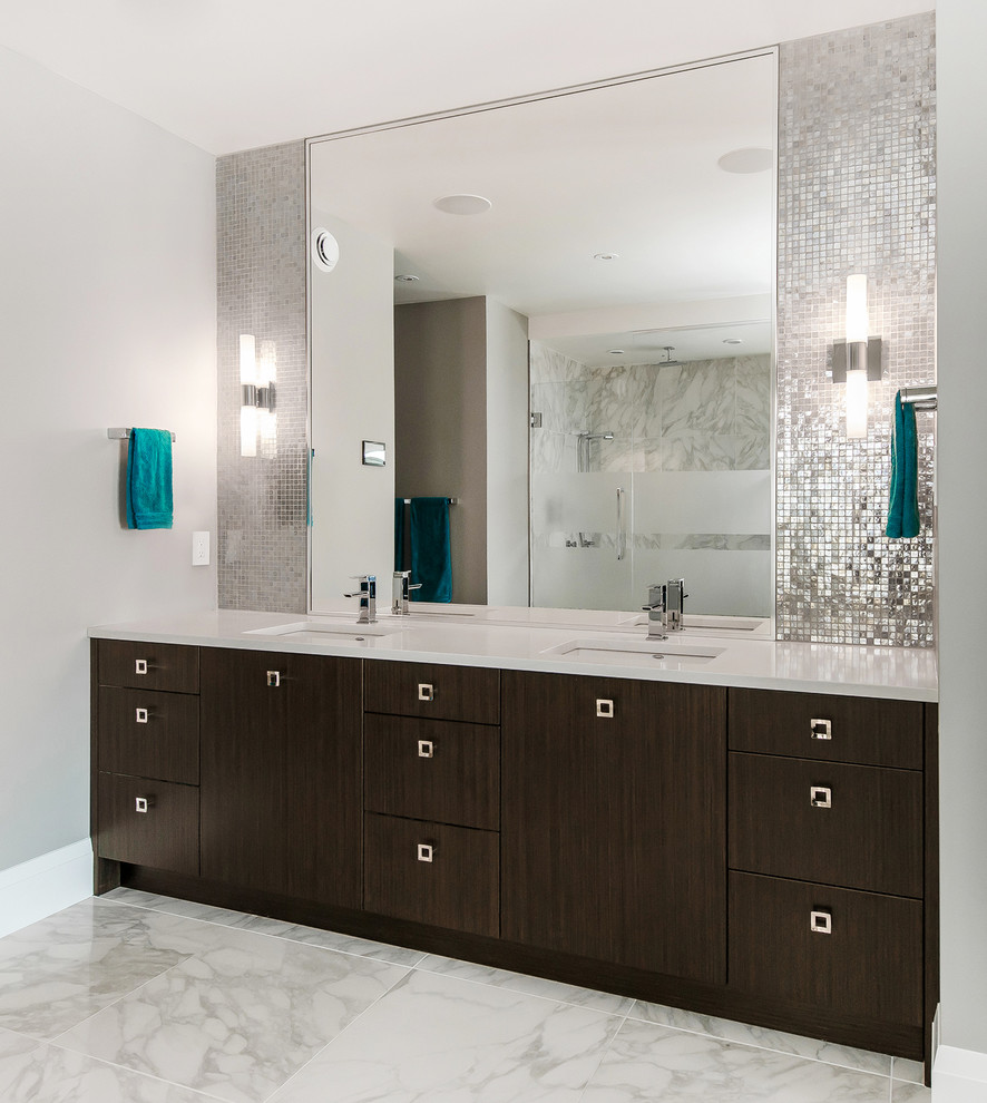 This is an example of a large contemporary master bathroom in Calgary with an undermount sink, flat-panel cabinets, dark wood cabinets, engineered quartz benchtops, an alcove shower, a one-piece toilet, gray tile, glass tile, grey walls and marble floors.