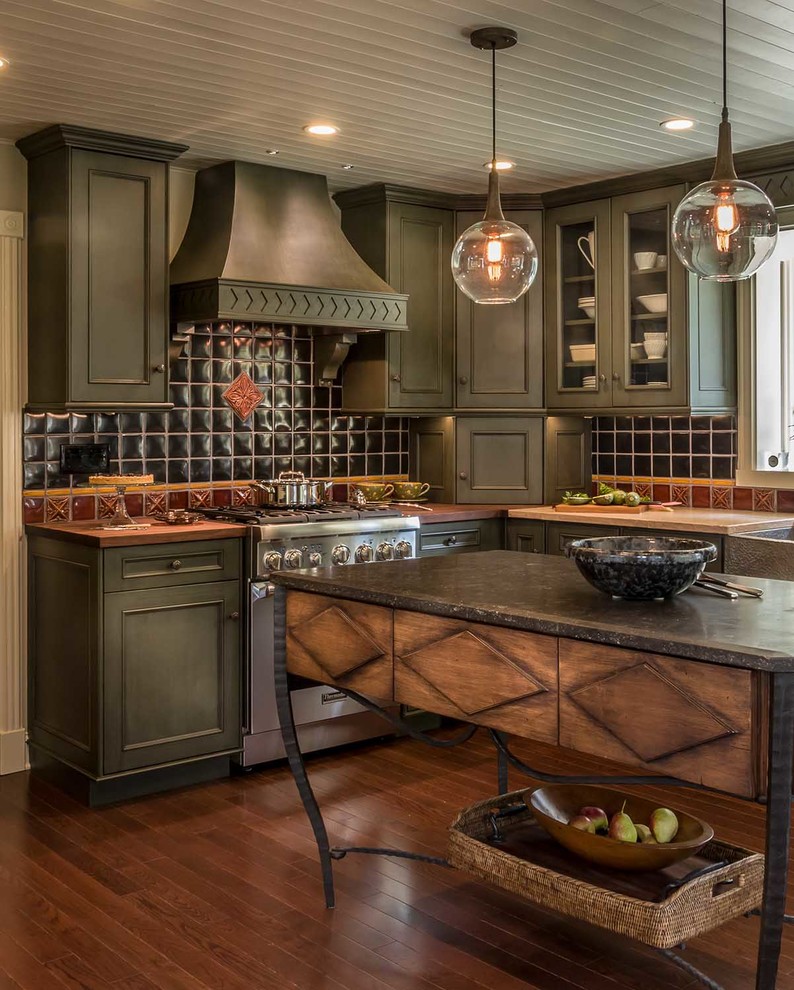 Photo of a traditional kitchen in Chicago with raised-panel cabinets, green cabinets, limestone benchtops, black splashback, stainless steel appliances, dark hardwood floors, with island and brown floor.