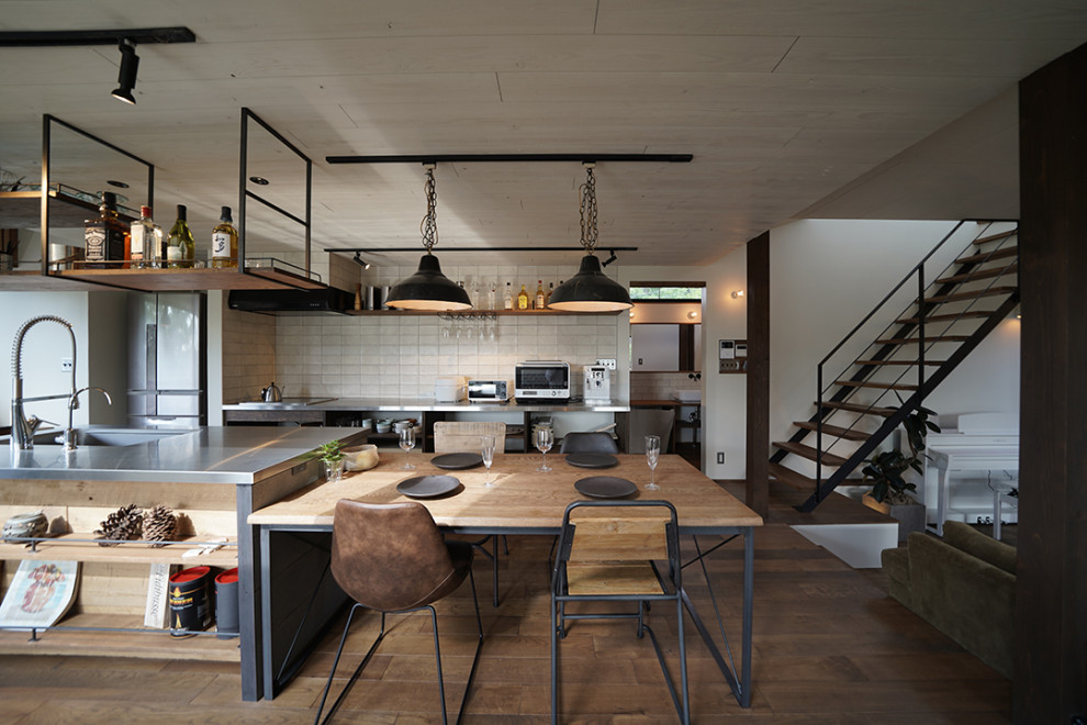 Photo of a medium sized industrial open plan dining room in Other with white walls, dark hardwood flooring, a wood burning stove, a concrete fireplace surround, brown floors, a timber clad ceiling, tongue and groove walls and feature lighting.