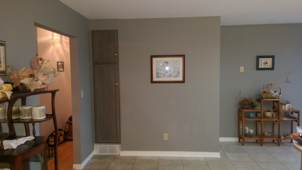 Example of a mid-sized transitional master vinyl floor and multicolored floor alcove bathtub design with recessed-panel cabinets, medium tone wood cabinets, a two-piece toilet, gray walls, laminate countertops and yellow countertops