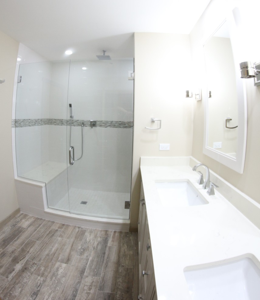 Alcove shower - mid-sized rustic master ceramic tile porcelain tile alcove shower idea in Chicago with recessed-panel cabinets, white cabinets, a two-piece toilet, beige walls, an undermount sink and quartz countertops