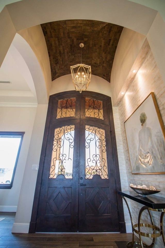 Mid-sized transitional medium tone wood floor and brown floor foyer photo with beige walls and a dark wood front door
