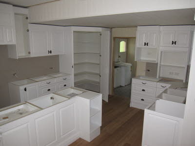 Design ideas for a mid-sized traditional l-shaped kitchen pantry in Brisbane with white cabinets, wood benchtops and with island.
