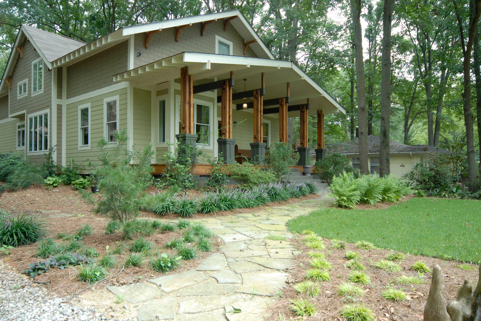 This is an example of a mid-sized arts and crafts two-storey green exterior in Atlanta with mixed siding.