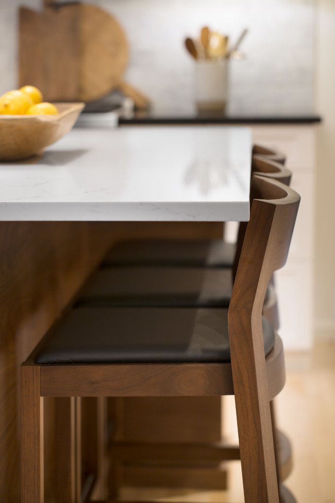 Mid-sized transitional l-shaped light wood floor and brown floor eat-in kitchen photo in Seattle with an undermount sink, shaker cabinets, white cabinets, quartz countertops, multicolored backsplash, marble backsplash, stainless steel appliances and an island