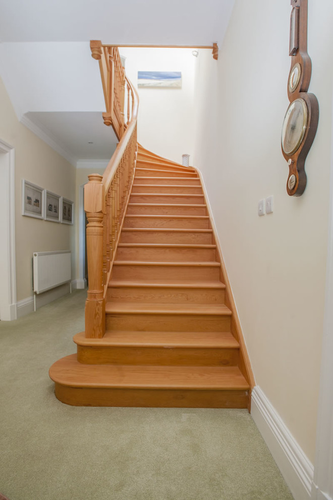 This is an example of a mid-sized traditional wood curved staircase in Other with wood risers.
