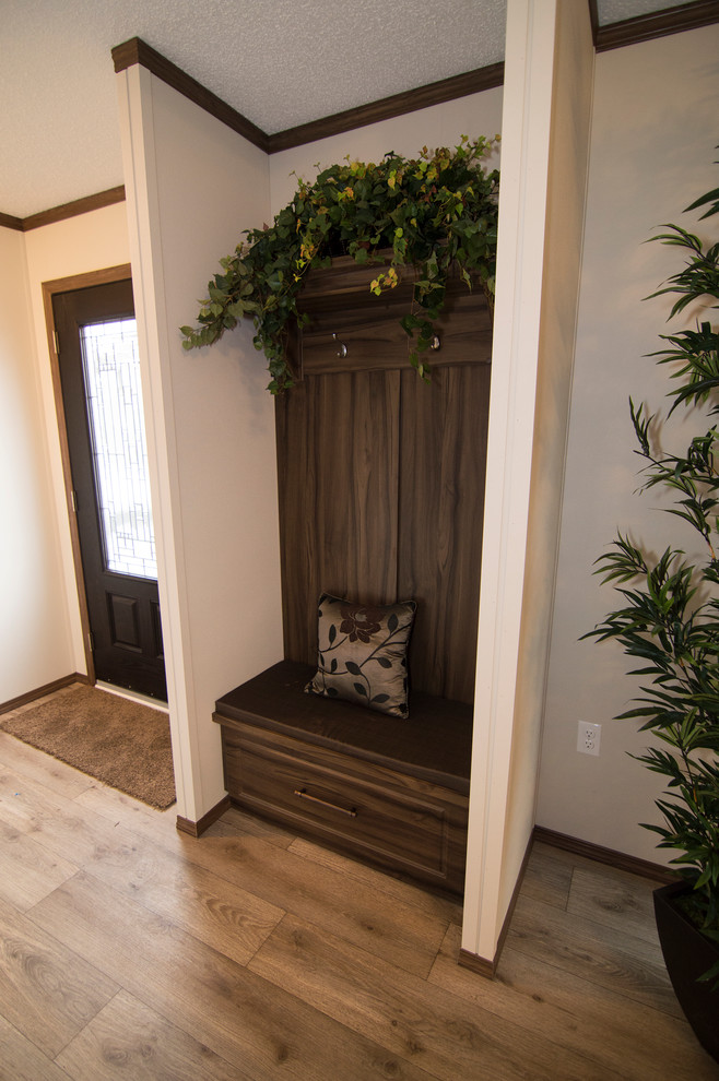Photo of a mid-sized country front door in Calgary with white walls, linoleum floors, a single front door and a black front door.