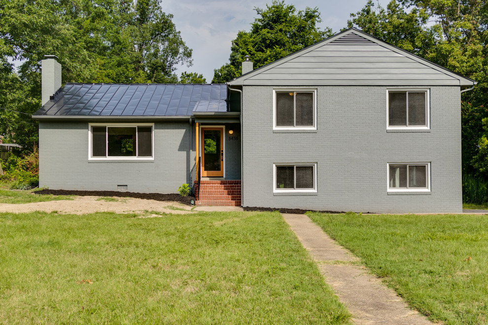 Mid-sized 1960s gray two-story brick house exterior photo in Richmond with a metal roof and a gray roof