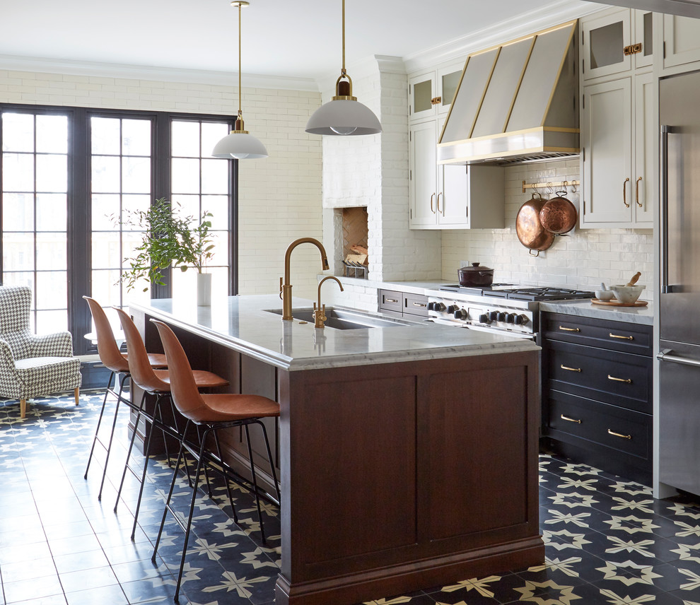 Transitional kitchen in Chicago with an undermount sink, shaker cabinets, black cabinets, white splashback, subway tile splashback, stainless steel appliances, with island, multi-coloured floor, grey benchtop, marble benchtops and cement tiles.
