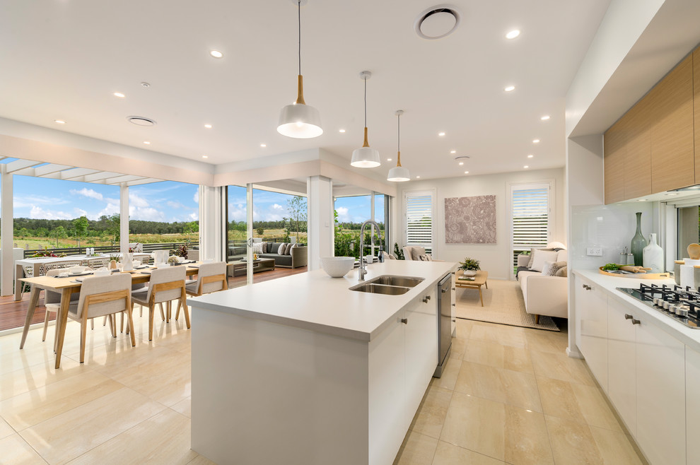 Inspiration for a large beach style galley open plan kitchen in Sydney with an undermount sink, flat-panel cabinets, light wood cabinets, quartz benchtops, window splashback, stainless steel appliances, ceramic floors, with island and yellow floor.