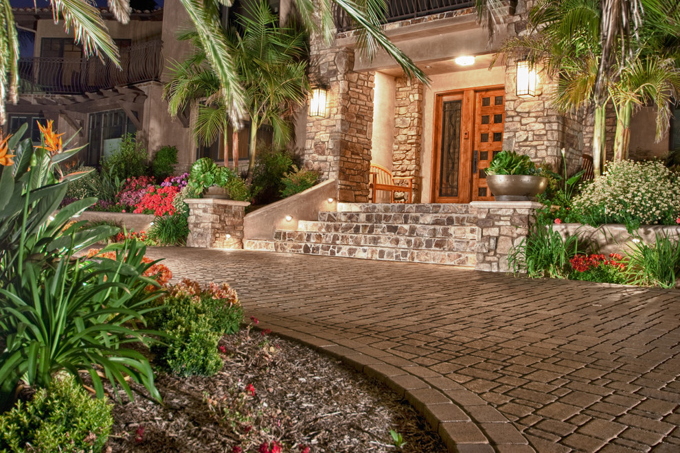 This is an example of an expansive mediterranean front yard driveway in San Diego with concrete pavers.