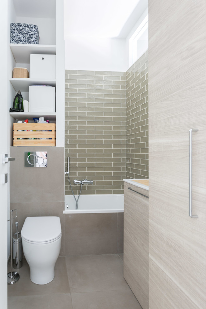 Small contemporary powder room in Milan with flat-panel cabinets, light wood cabinets, multi-coloured walls, porcelain floors and grey floor.