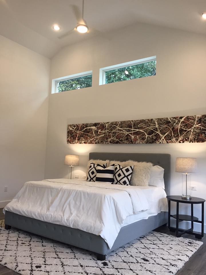 Design ideas for a large contemporary master bedroom in Austin with white walls, dark hardwood floors, no fireplace and grey floor.