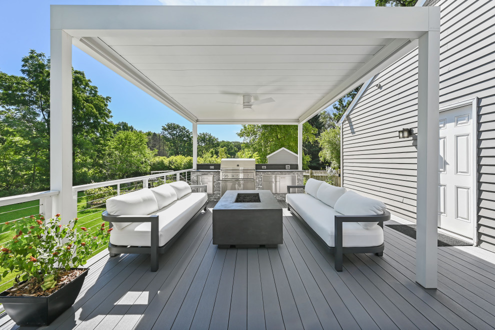 Photo of a contemporary backyard and first floor deck in Chicago with an outdoor kitchen and cable railing.
