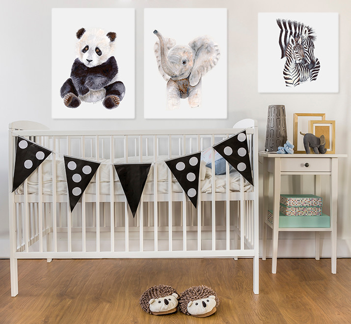 Photo of a transitional gender-neutral nursery in San Diego with white walls and medium hardwood floors.