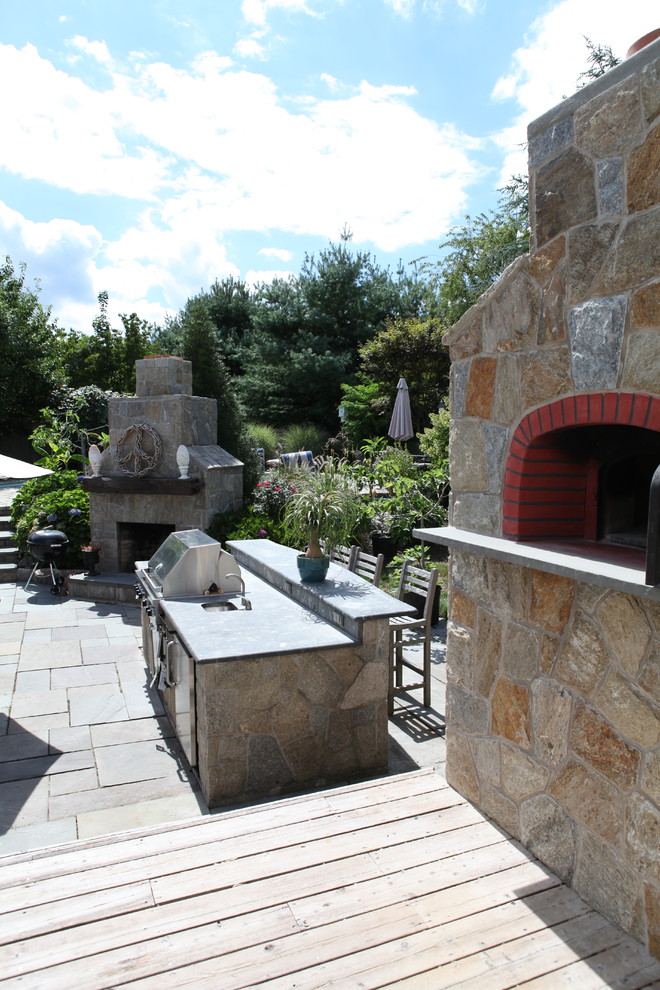 Inspiration for a large transitional backyard patio in New York with an outdoor kitchen, decking and a pergola.