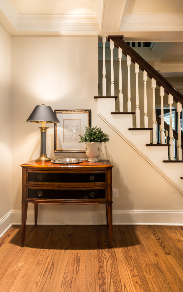 Inspiration for a small transitional medium tone wood floor foyer remodel with beige walls