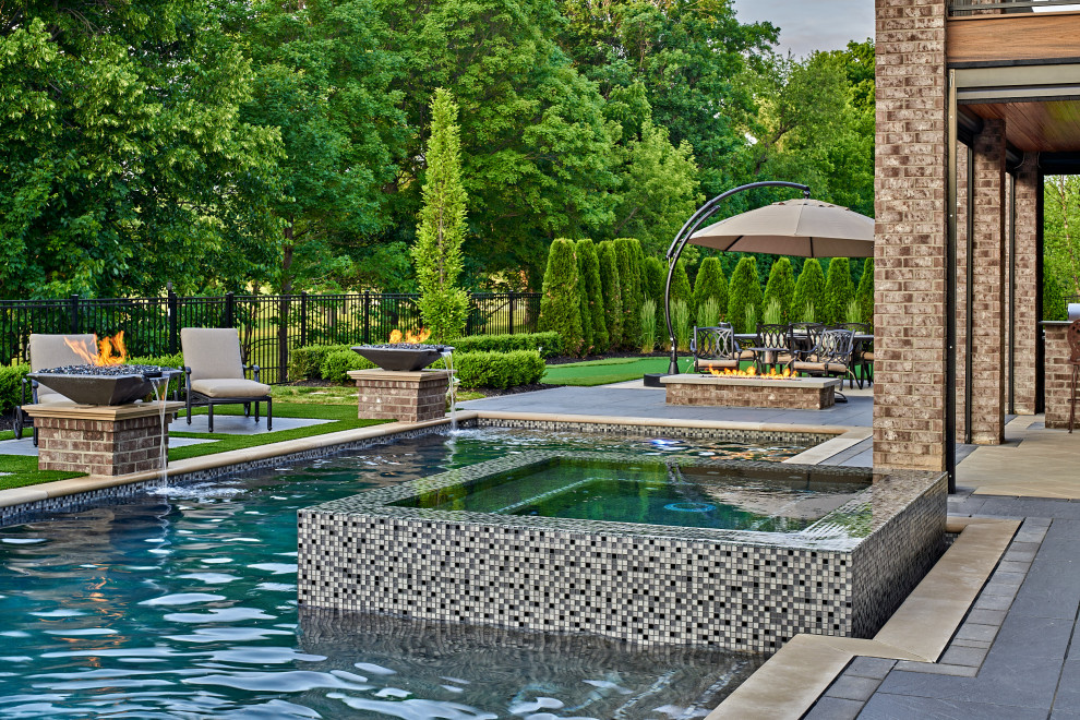 Mid-sized contemporary backyard custom-shaped pool in Detroit with a hot tub and concrete pavers.