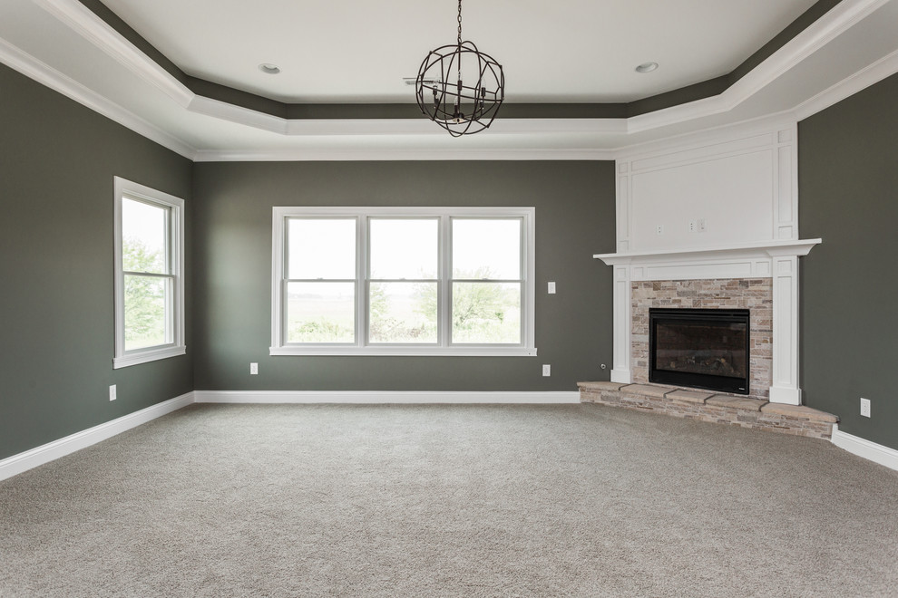 Large arts and crafts master bedroom in Indianapolis with grey walls, carpet, a corner fireplace and a tile fireplace surround.
