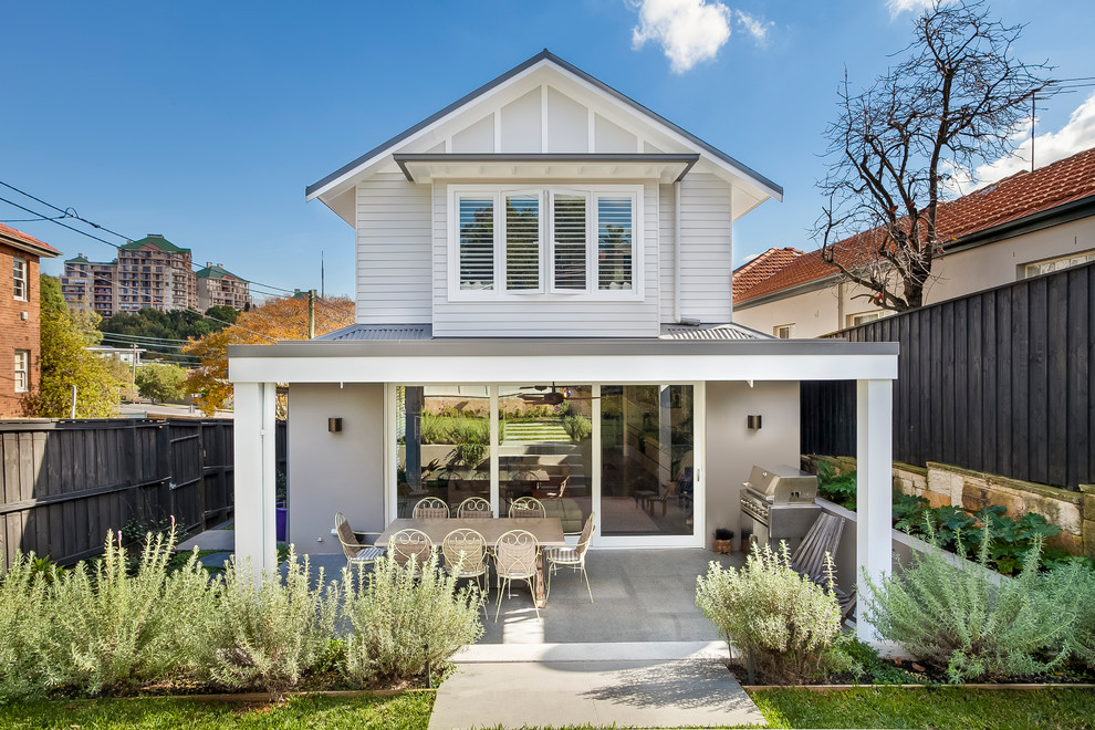 Inspiration for a mid-sized beach style two-storey grey house exterior in Sydney with a gable roof, a metal roof and mixed siding.