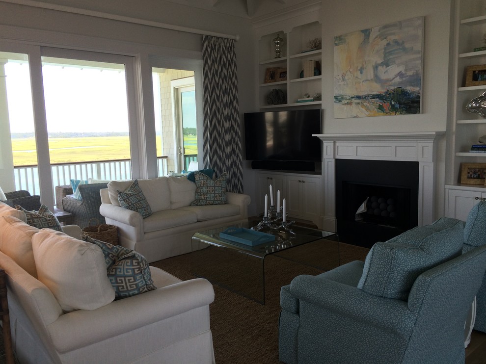 Inspiration for a large beach style family room in Wilmington with grey walls, light hardwood floors and a built-in media wall.