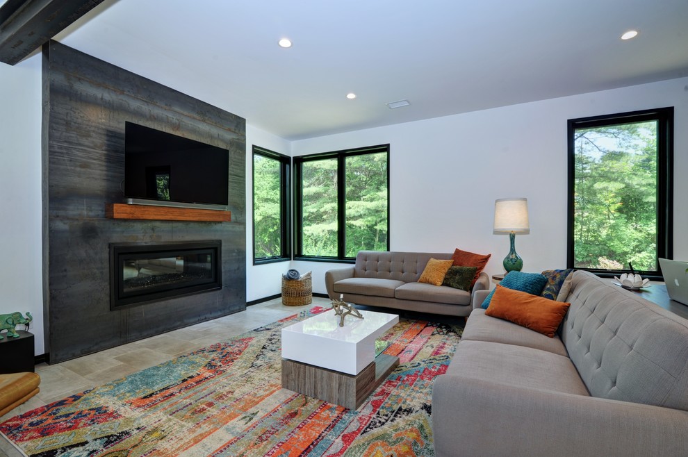 Design ideas for a midcentury open concept living room in Other with white walls, ceramic floors, a standard fireplace, a metal fireplace surround, a wall-mounted tv and grey floor.