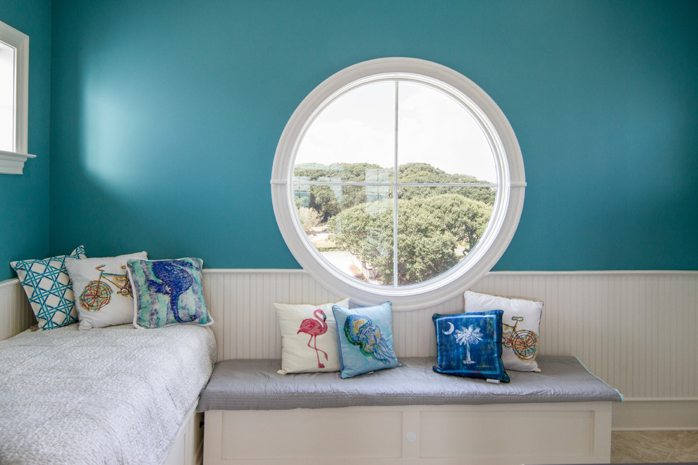 Photo of a beach style gender-neutral kids' room in Other with blue walls.