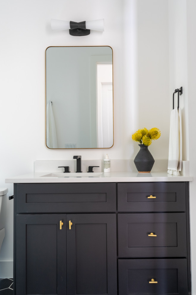 This is an example of a transitional bathroom in Austin with shaker cabinets, black cabinets, white tile, porcelain tile, white walls, engineered quartz benchtops, white benchtops, a single vanity and a built-in vanity.
