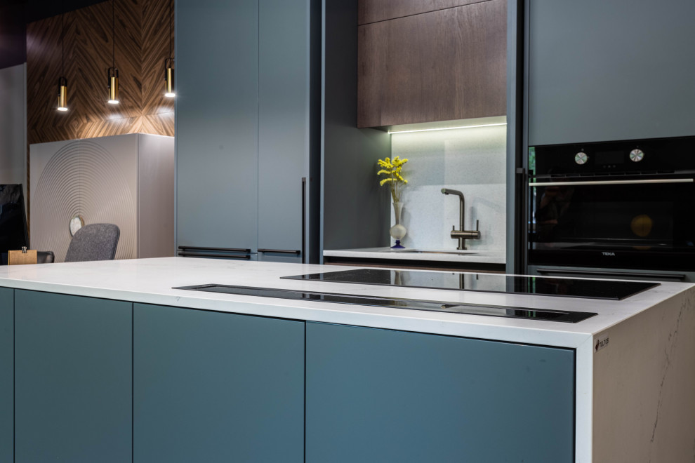 Design ideas for a medium sized contemporary grey and white galley kitchen/diner in Saint Petersburg with blue cabinets, engineered stone countertops, white splashback, engineered quartz splashback, an island and white worktops.