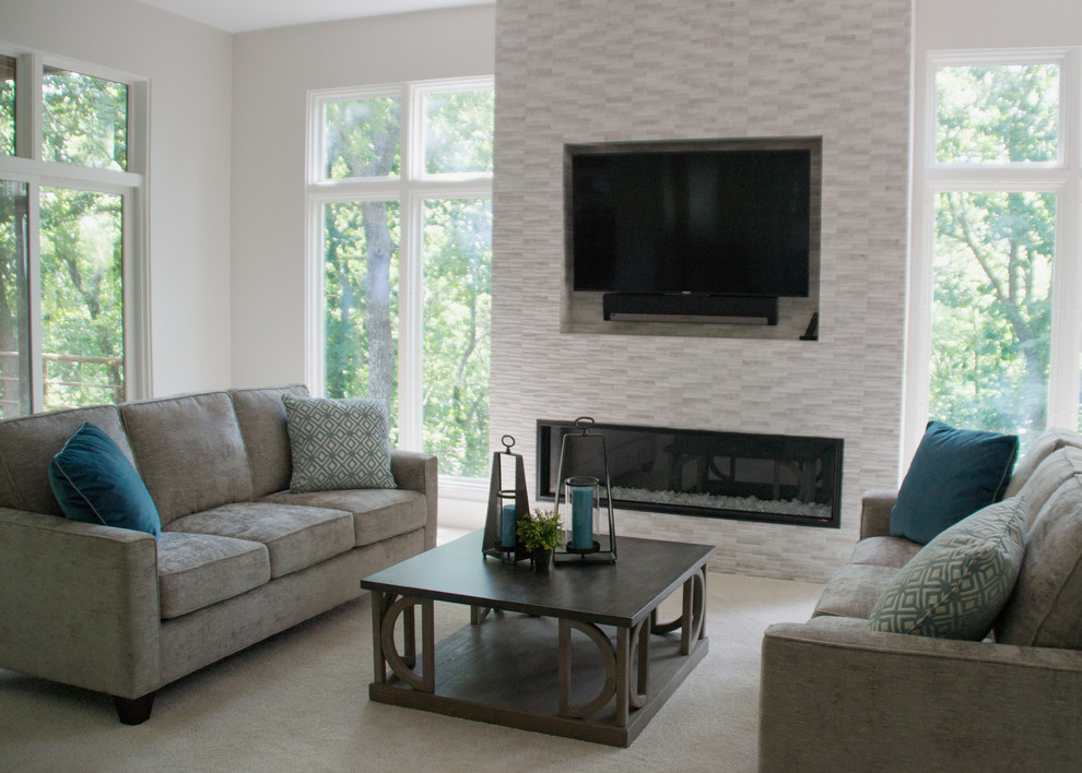 Inspiration for a large contemporary open concept living room in Other with white walls, carpet, a hanging fireplace, a tile fireplace surround, a wall-mounted tv and beige floor.